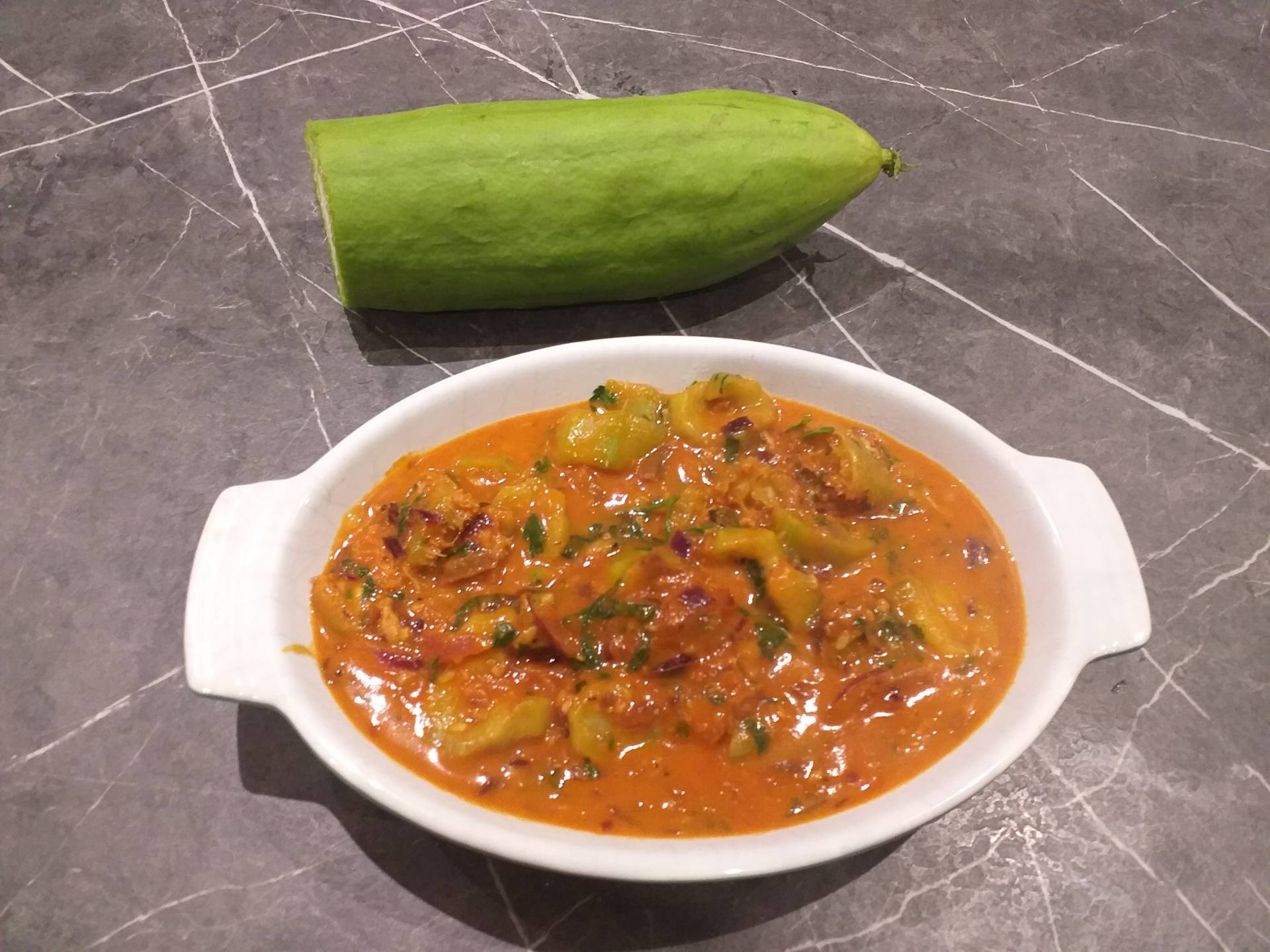 This is a photo of Stuart's loofah in tomato sauce, served in a bowl.