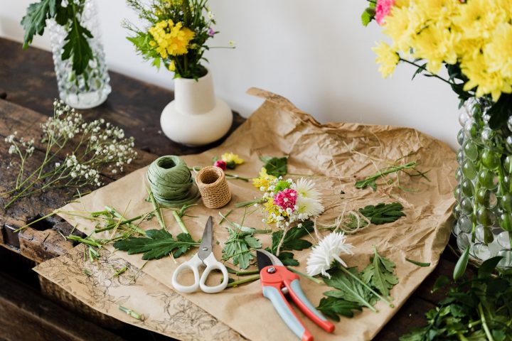 This is a photo of a table with floristy tools and materials on it.